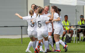 New Zealand's Kelli Brown (facing) celebrates scoring the opening goal of the match.