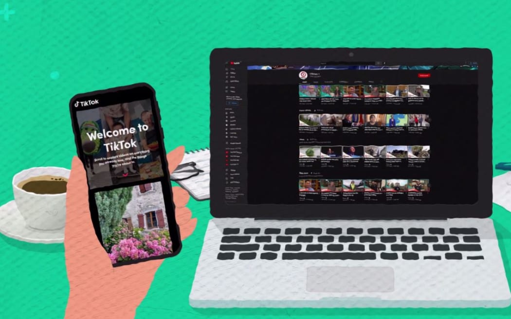 A laptop sits on a table next to a cup of coffee. The screen shows internet videos from TVNZ. A hand holds up a smartphone open to the app TikTok.