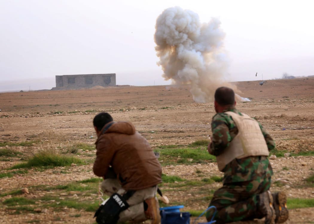 Kurdish peshmerga fighters detonate a landmine planted by IS on the outskirts of the village of Sinuni in the northern Iraqi district of Sinjar on 15 January 2015.