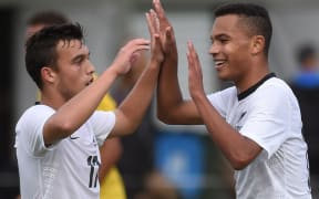 Clayton Lewis and Elijah Neblett celebrate a goal against Papua New Guinea, Auckland, 2014.