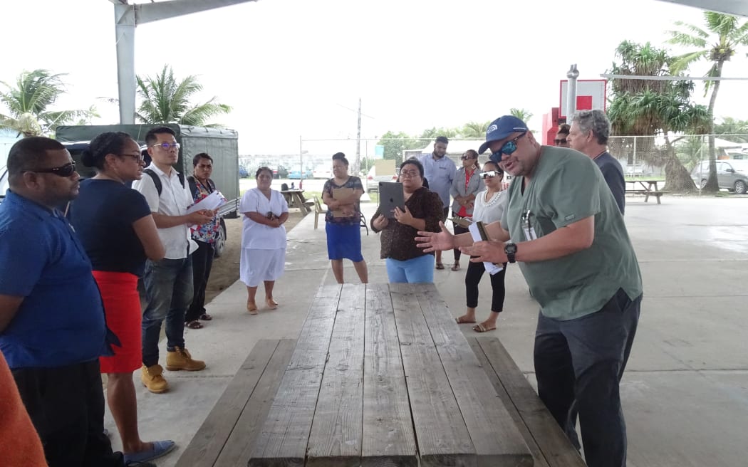 Marshall Islands Director of Public Health Dr. Frank Underwood, right, leads an exercise with health staff preparing for their response to community spread of Covid in the future.
