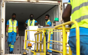 Airport workers unload a shipment of Covid-19 vaccines from the Covax programme, at Kotoka International Airport in Accra, 24 February 2021.
