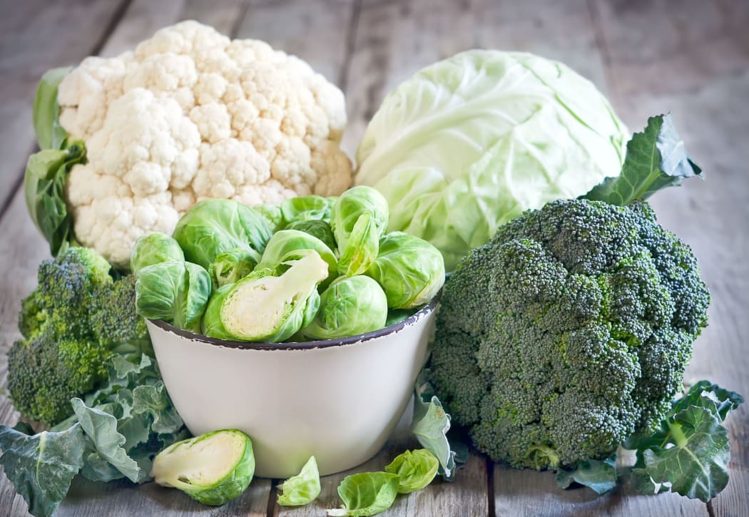 Assortment of cabbages on old wood background