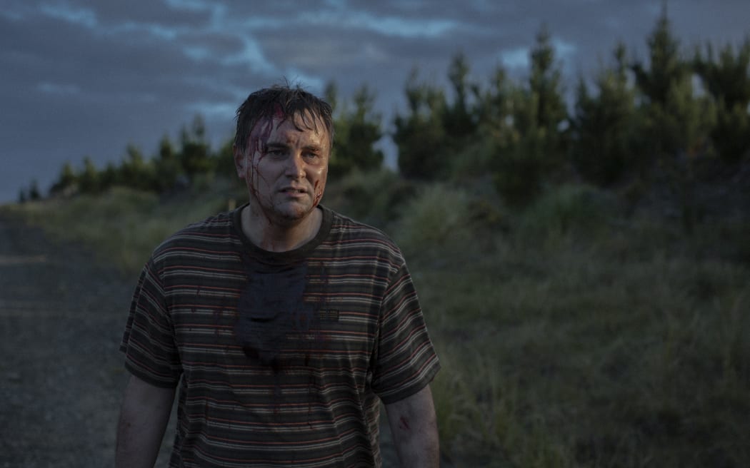 Sweaty and bloody man in his early 40s alone in the New Zealand bush.