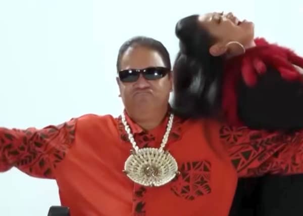 Fonotī Pati Umaga wears sunglasses and a Samoan necklace as he makes a silly face.