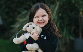 little girl with stuffed toy