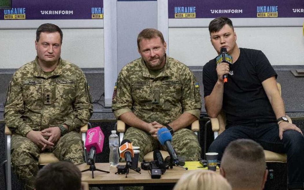 Former Russian pilot Maksym Kuzminov (left), with Ukrainian defence personnel, at a press conference in September, following his August 2023 defection across the border to Ukraine with a Russian helicopter.