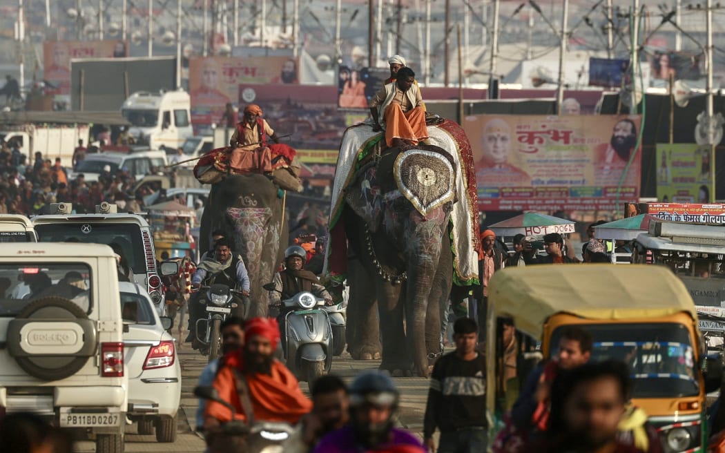 Mahouts ride elephants as they leave after a religious procession ahead of the Maha Kumbh Mela festival in Prayagraj on January 11, 2025. (Photo by Niharika KULKARNI / AFP)