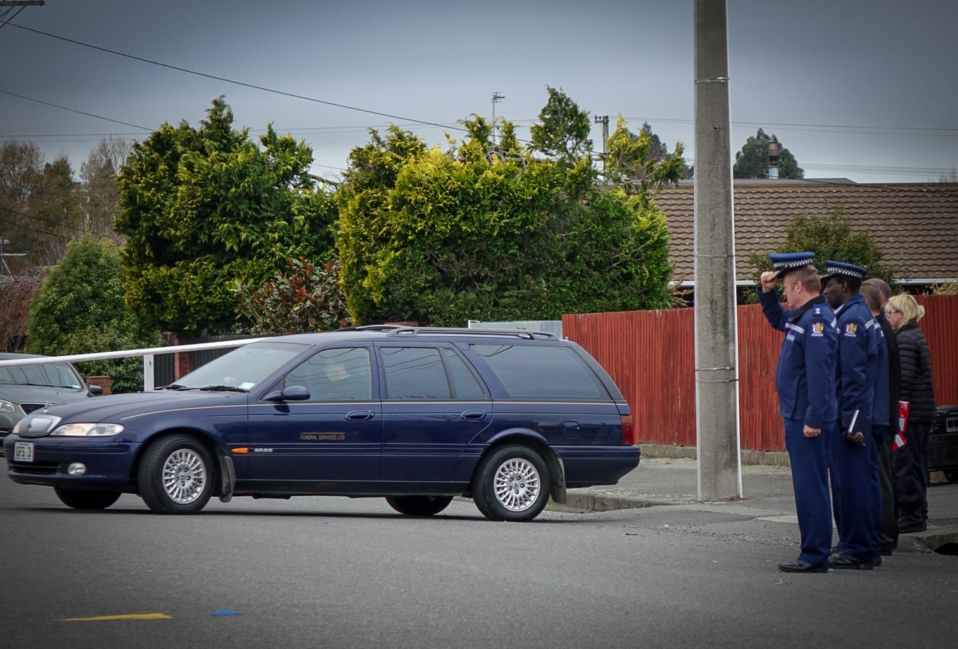 Funeral caretakers leaving the property.