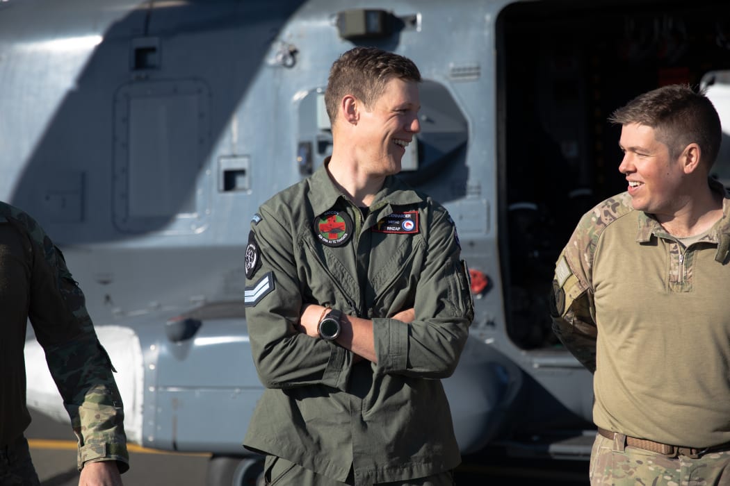 Jase Denharder (left) was the first person the two trampers saw when he was winched down from a helicopter not far above them.