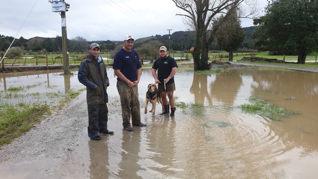 Sam Davis, centre, says three quarters of his Northland Dairy farm was underwater