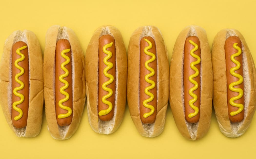 Hot dogs against a plain background. (Photo by SCIENCE PHOTO LIBRARY / R3F / Science Photo Library via AFP)