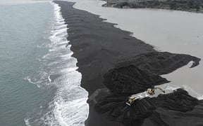 Hamish Pryde and a worker from Pryde Contracting were busy opening up the Wairoa River mouth last month in an effort to avert a flooding disaster for the township and low-lying areas.