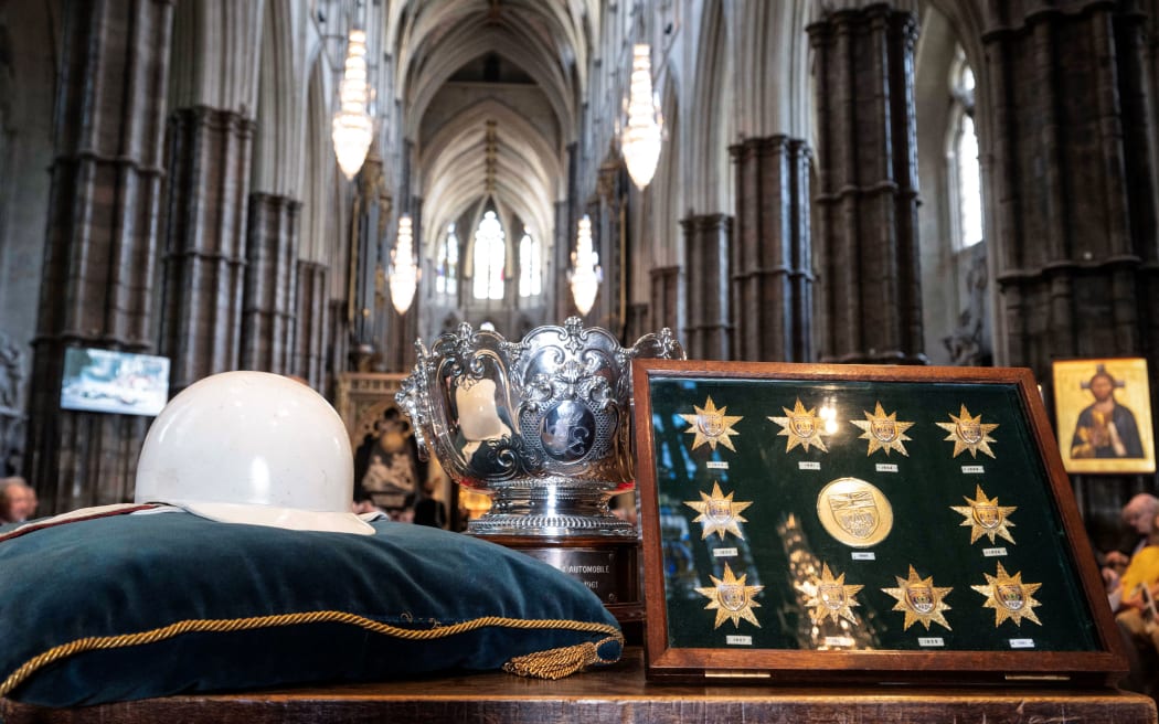 Stirling Moss’s white helmet, his ten British Racing Driving Club Gold and his Monaco 1961 trophy are pictured during a service of Thanksgiving for late British Formula One driver Stirling Moss at Westminster Abbey, central London, on 8 May, 2024.