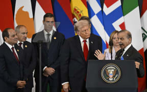 US President Donald Trump (C) listens to Pakistan's Prime Minister Shehbaz Sharif (R) as he delivers a statement during a summit on Gaza in Sharm el-Sheikh on October 13, 2025. Trump landed in Egypt on October 13 for a summit on Gaza, following a lightning visit to Israel after a ceasefire he brokered entered into force. (Photo by Khaled DESOUKI / AFP)