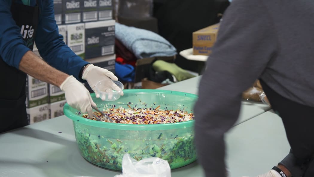 Volunteers prepare meals at Papakura Marae for those in need as unemployment rises.