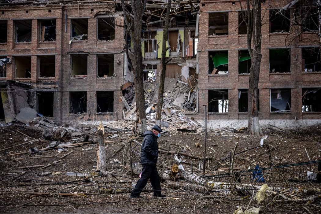 A man walks in front of a destroyed building after a Russian missile attack in the town of  Vasylkiv, near Kyiv, on February 27, 2022.