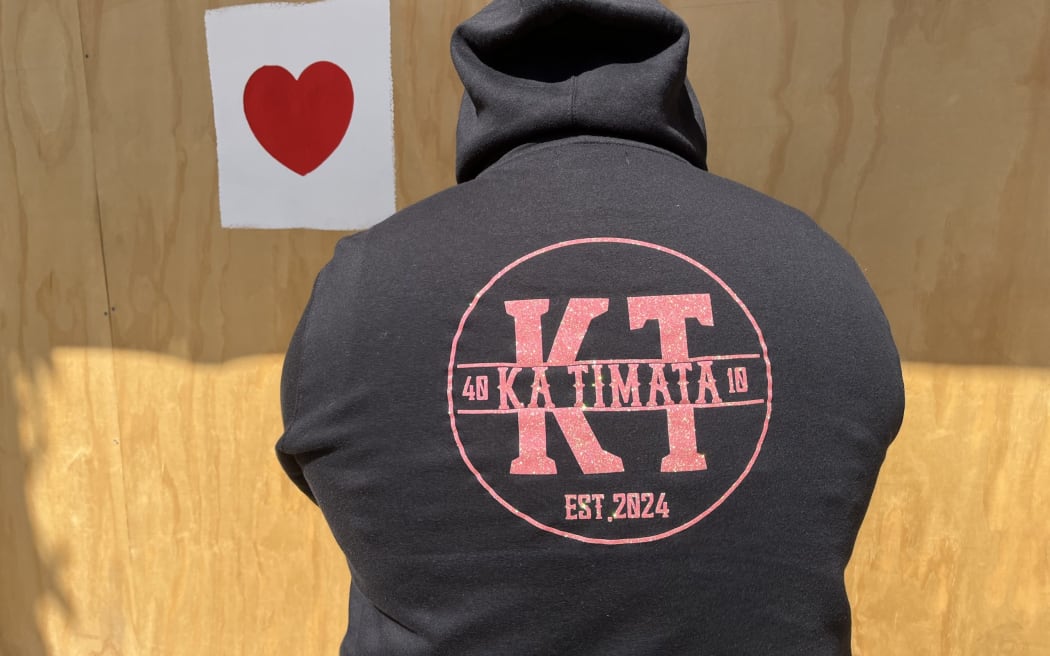 Ka Timata youth group founder Freddy Bishop wearing a group hoodie designed by one of the kids. Bishop says the mural they will paint as a group on Sunday will say: "We're here."