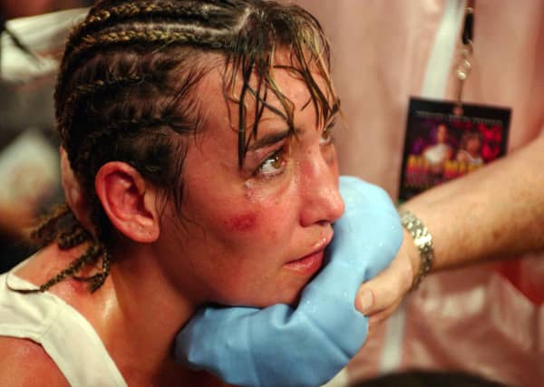 Christy Martin rests during a boxing match in August 2003.