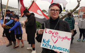 Whangārei resident Jenni Moore makes her views known during the pre-meeting rally.