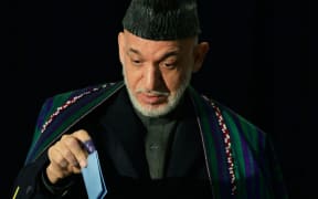 Hamid Karzai casts his vote at a Kabul polling station.