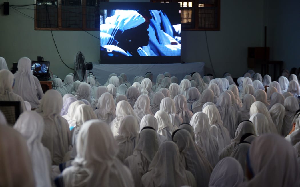 Indian Nuns from the Catholic Order of the Missionaries of Charity, watch a live telecast of the canonisation of Mother Teresa from Rome, at The Mother House in Kolkata