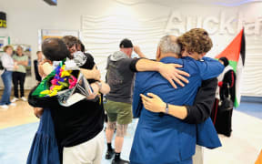 Samuel Leason, one of the three New Zealanders who was detained and deported hugging loved ones.