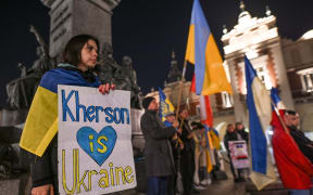 Ukrainians people living in Krakow and their supporters are seen during the Solidarity With Ukraine protest in Krakow's Main Square, on the 232nd day of the Russian invasion of Ukraine. 
On Wednesday, November 09, 2022, in Krakow, Lesser Poland Voivodeship, Poland. (Photo by Artur Widak/NurPhoto) (Photo by Artur Widak / NurPhoto / NurPhoto via AFP)