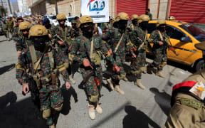 Forces loyal to Yemen's Houthi group take part in a military parade marking the seventh anniversary of the Saudi-led coalition's intervention in their country, in the capital Sanaa, on March 31, 2022.