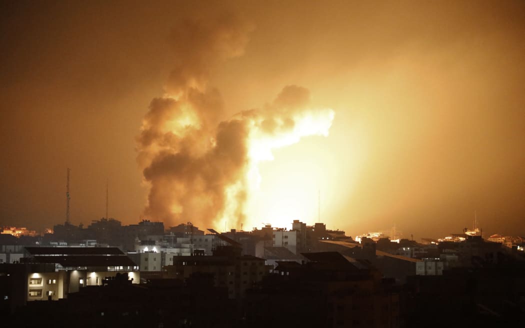 Fire and smoke rises above buildings during an Israeli air strike in Gaza City on October 8, 2023.