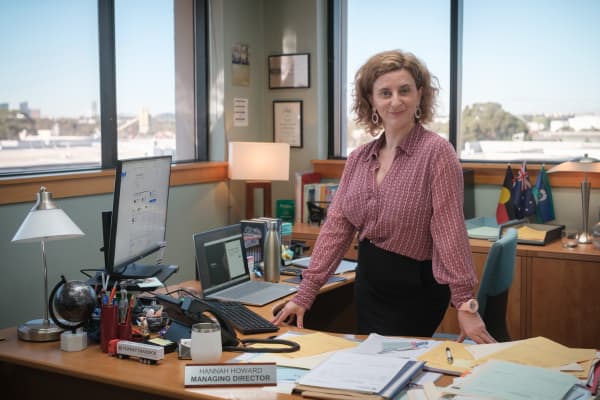Hannah Howard (Felicity Ward) is hell-bent on keeping her "work family" together, even if it means lying about false orders to work from the office and subjecting everyone to TGIF Fridays.