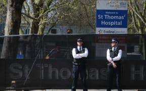 Police officers stand on duty outside St Thomas' Hospital in central London on April 7, 2020. where Britain's Prime Minister Boris Johnson is in intensive care.