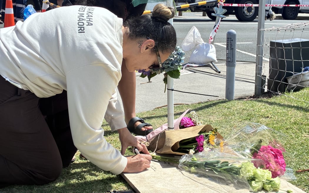 Family pay respects at the Mt Maunganui landslide cordon.