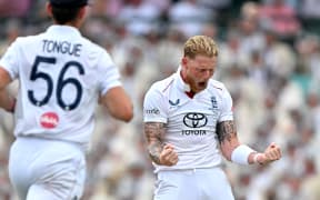 England's captain Ben Stokes (R) celebrates after taking the wicket of Australia's Jake Weatherald on day two of the fifth Ashes cricket Test between Australia and England at the Sydney Cricket Ground in Sydney on January 5, 2026. (Photo by Saeed KHAN / AFP) / -- IMAGE RESTRICTED TO EDITORIAL USE - STRICTLY NO COMMERCIAL USE --