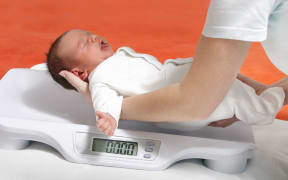 baby boy on weight scale