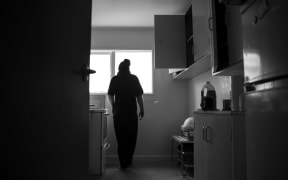 Man silouhetted in flat kitchen