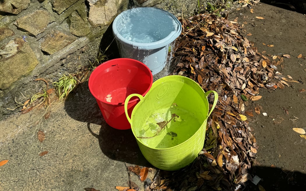 The leak on Manuka Street is pouring out one litre every second Catherine's buckets are overflowing in less than a minute.