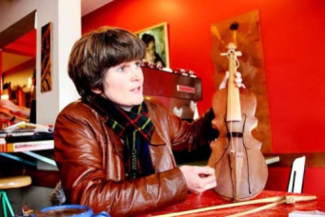 Megan Collins holding a rabab, used in West Sumatra to accompany migration stories