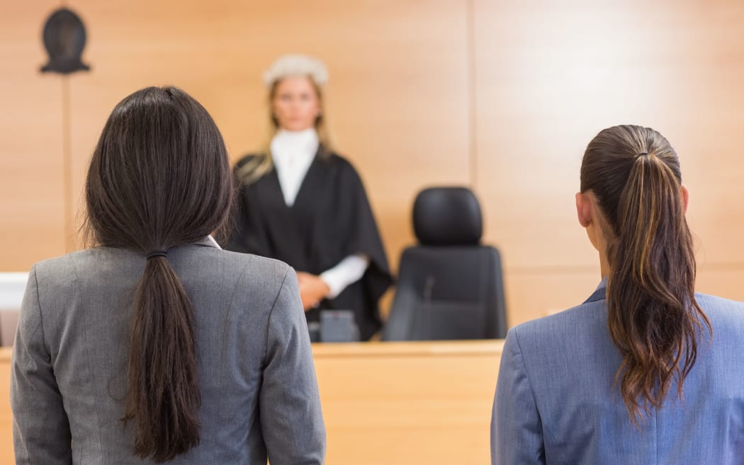 Lawyers listening to the judge in the court room