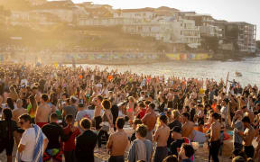 Thousands of people have gathered at Bondi Beach to paddle out into the water to hold a minute's silence for the victims killed during Sunday's attack.