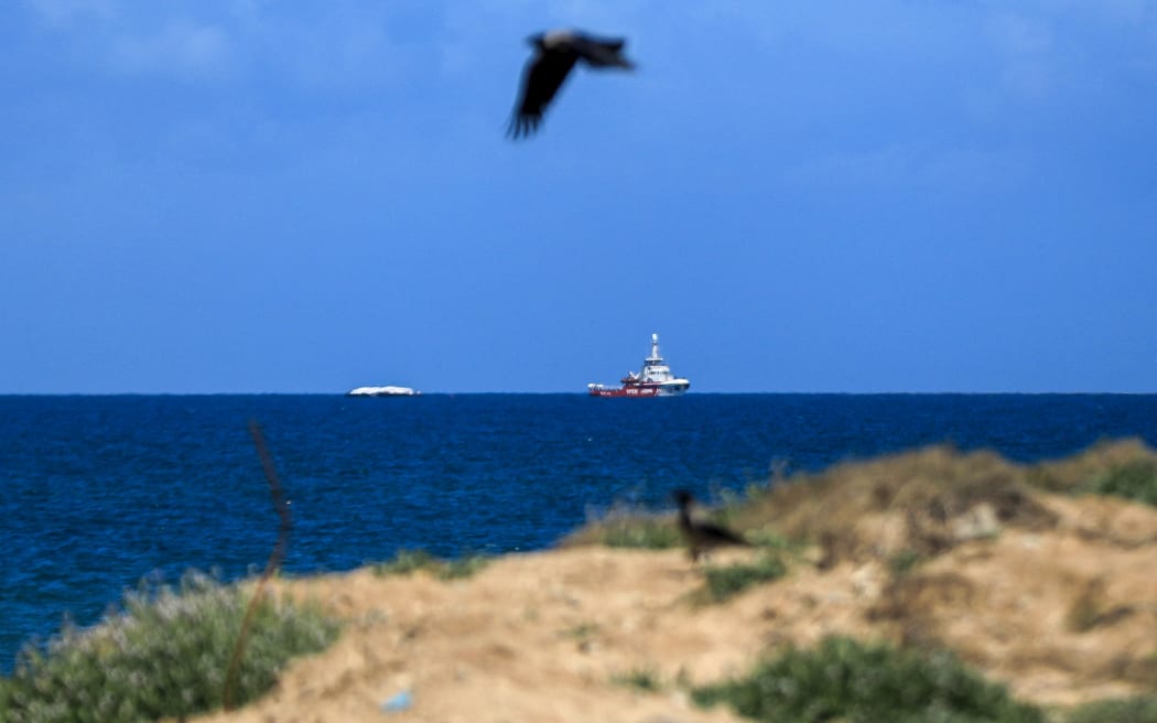 The Open Arms maritime vessel that set sail from Larnaca in Cyprus carrying humanitarian aid approaches the coast of Gaza City on March 15, 2024. The Open Arms, which the Spanish charity operating it says is carrying 200 tonnes of food for Gazans threatened with famine after more than five months of war via a new maritime corridor, was visible on the war-ravaged territory on March 15. (Photo by Yasser Qudihe / Middle East Images / Middle East Images via AFP)