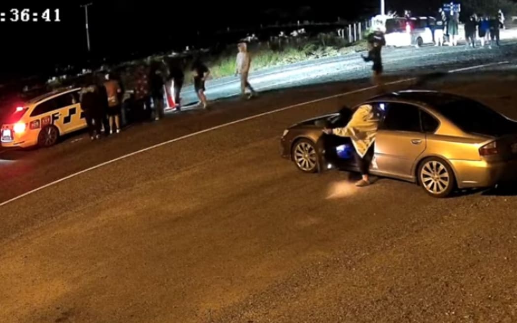 Police officers retreated after their car was surrounded by what they describe as a "hostile" group of people at a car meet in Taranaki early this morning.