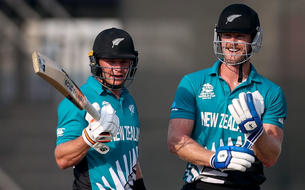 Glenn Phillips, left, and team mate James Neesham talk tactics against Namibia.