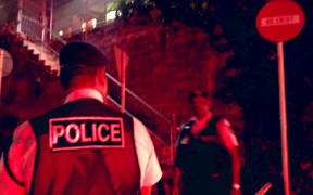 Fiji police officers standing outside the Criminal Investigations Department in Toorak where Sitiveni Rabuka was taken for questioning. 16 December 2022