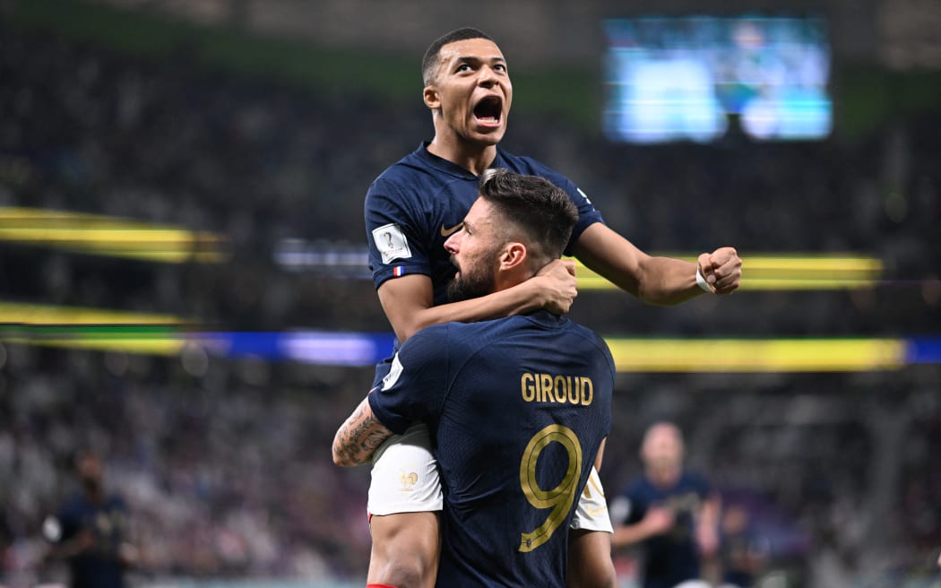 France forward Olivier Giroud celebrates with Kylian Mbappe after scoring his team's first goal during the Qatar 2022 World Cup round of 16 football match between France and Poland at the Al-Thumama Stadium in Doha on 4 December, 2022.