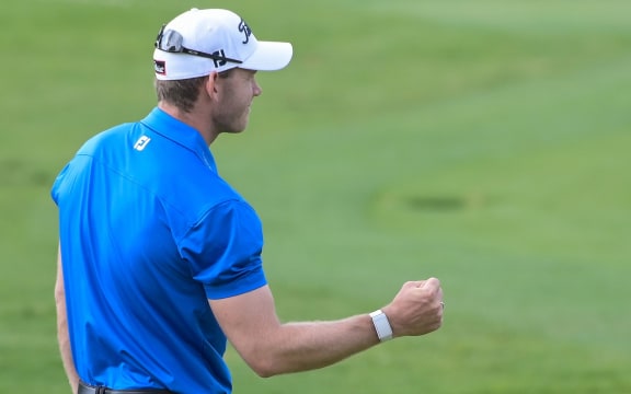 Joachim B. Hansen of Denmark pumps his fist as he sinks his winning put during the final round of the Joburg Open golf tournament held at the Randpark Golf Club in Johannesburg on November 22, 2020.