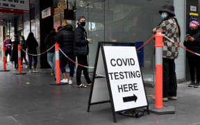 People queue at a Covid-19 testing station in Melbourne on 25 May 2021 as the city recorded five new coronavirus cases in the community.
