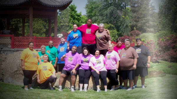 A screenshot taken from Fit for TV: The Reality of the Biggest Loser. showing a group of overweight people in brightly coloured t-shirts.