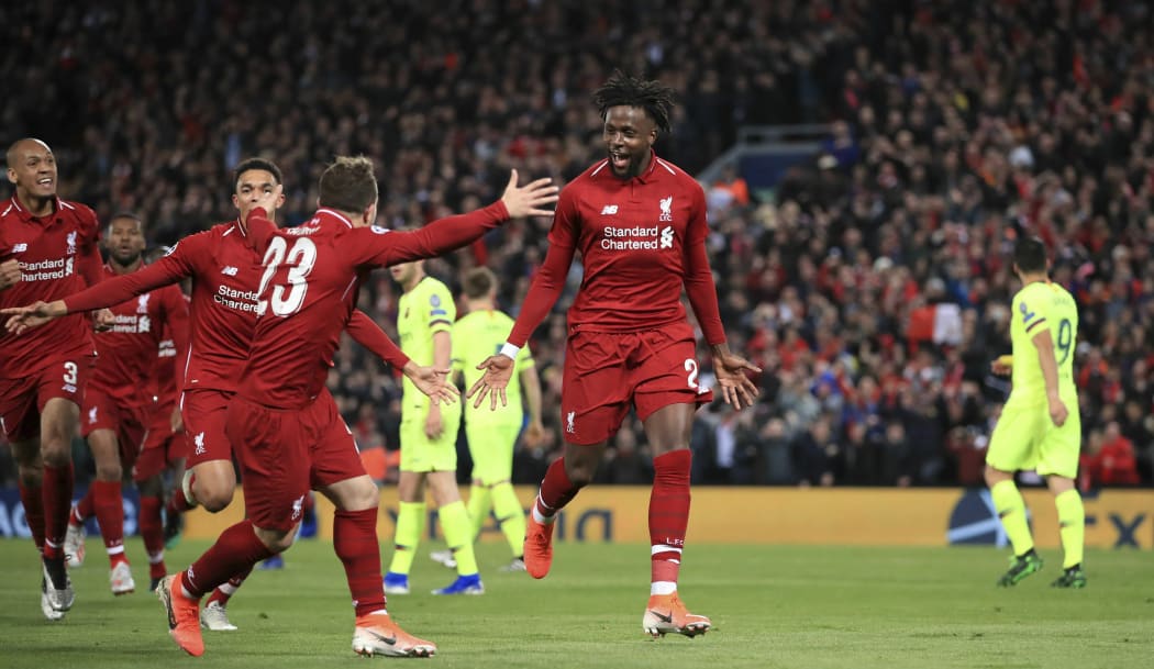 Liverpool's Divock Origi, center, celebrates scoring his side's fourth goal during the Champions League Semi Final between Liverpool and Barcelona at Anfield