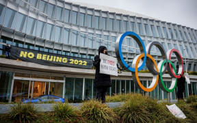 Tibetan activists from the Students for a Free Tibet association holds a banner during a protest in front of the International Olympic Committee (IOC) headquarters ahead of the February's Beijing 2022 Winter Olympics,